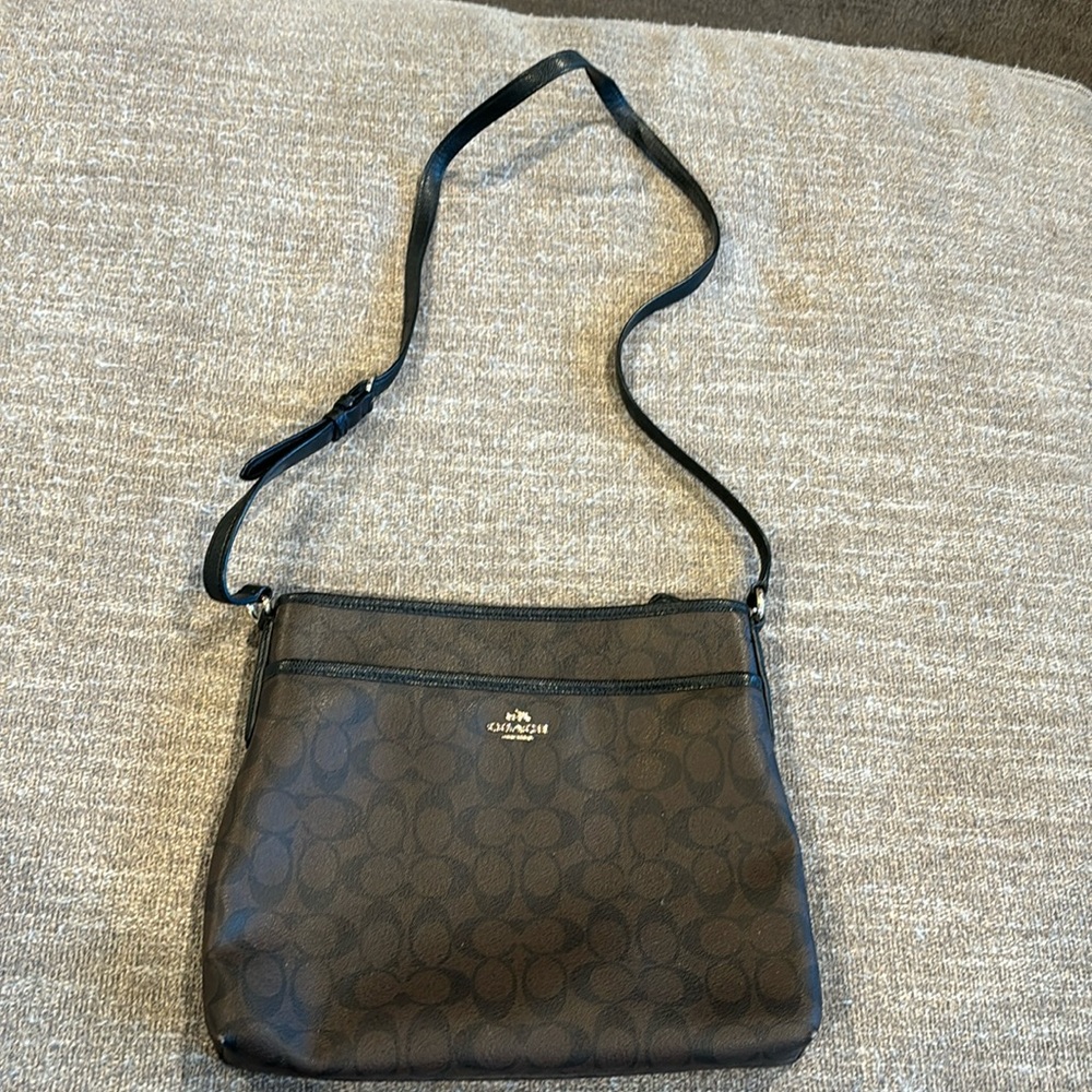 COACH crossbody bag, 12’ wide x 10’ deep, dark brown with COACH logo.